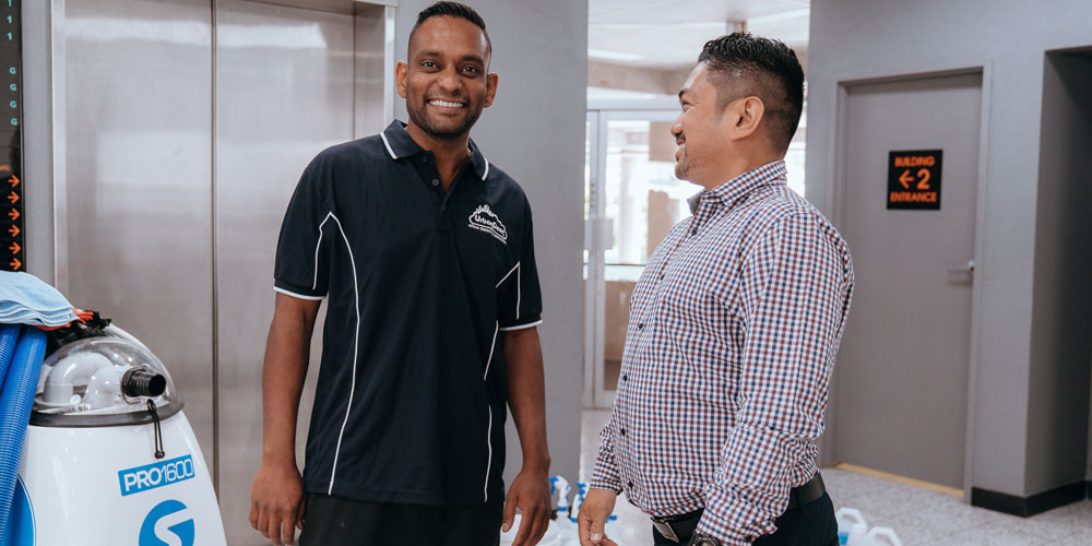 Urban Clean franchisee shaking hands with a client.